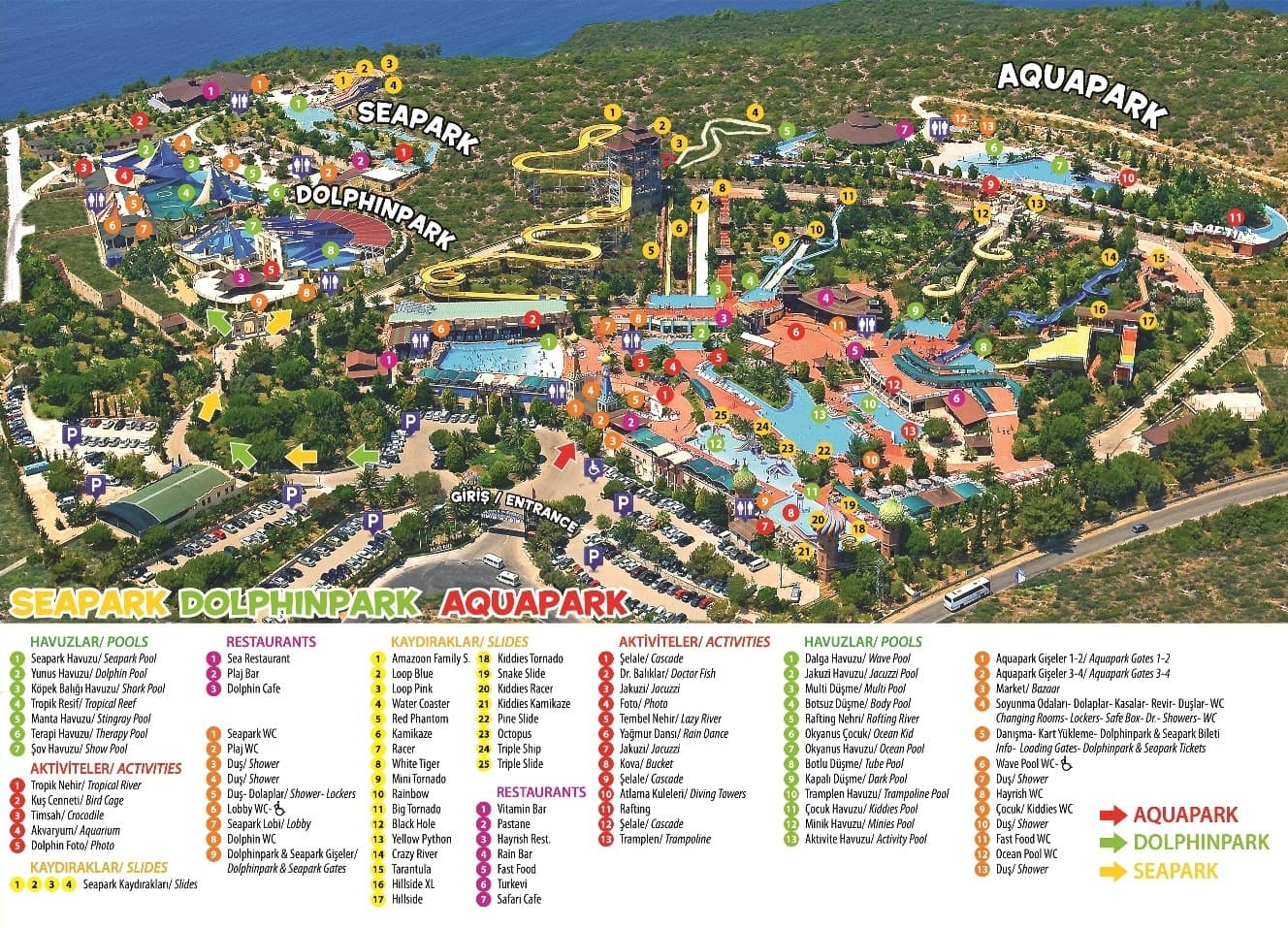 Bright twisting waterslides curving above a sunny aquapark pool.