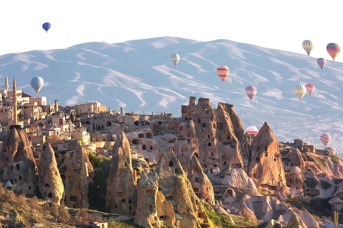 An Anatolian caravanserai with tall stone arches at golden hour.