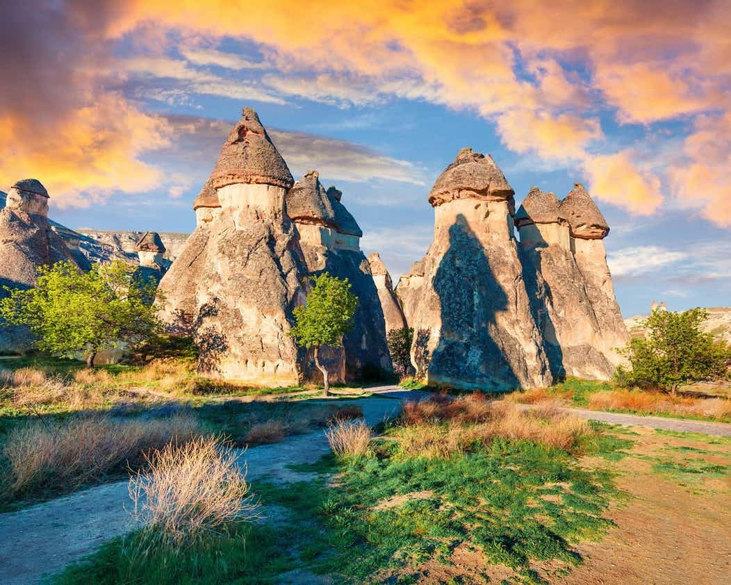 An Anatolian caravanserai with tall stone arches at golden hour.