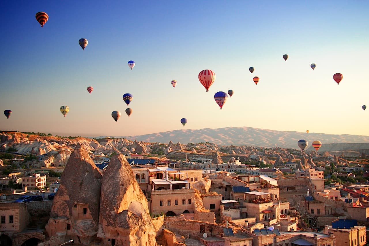 An Anatolian caravanserai with tall stone arches at golden hour.