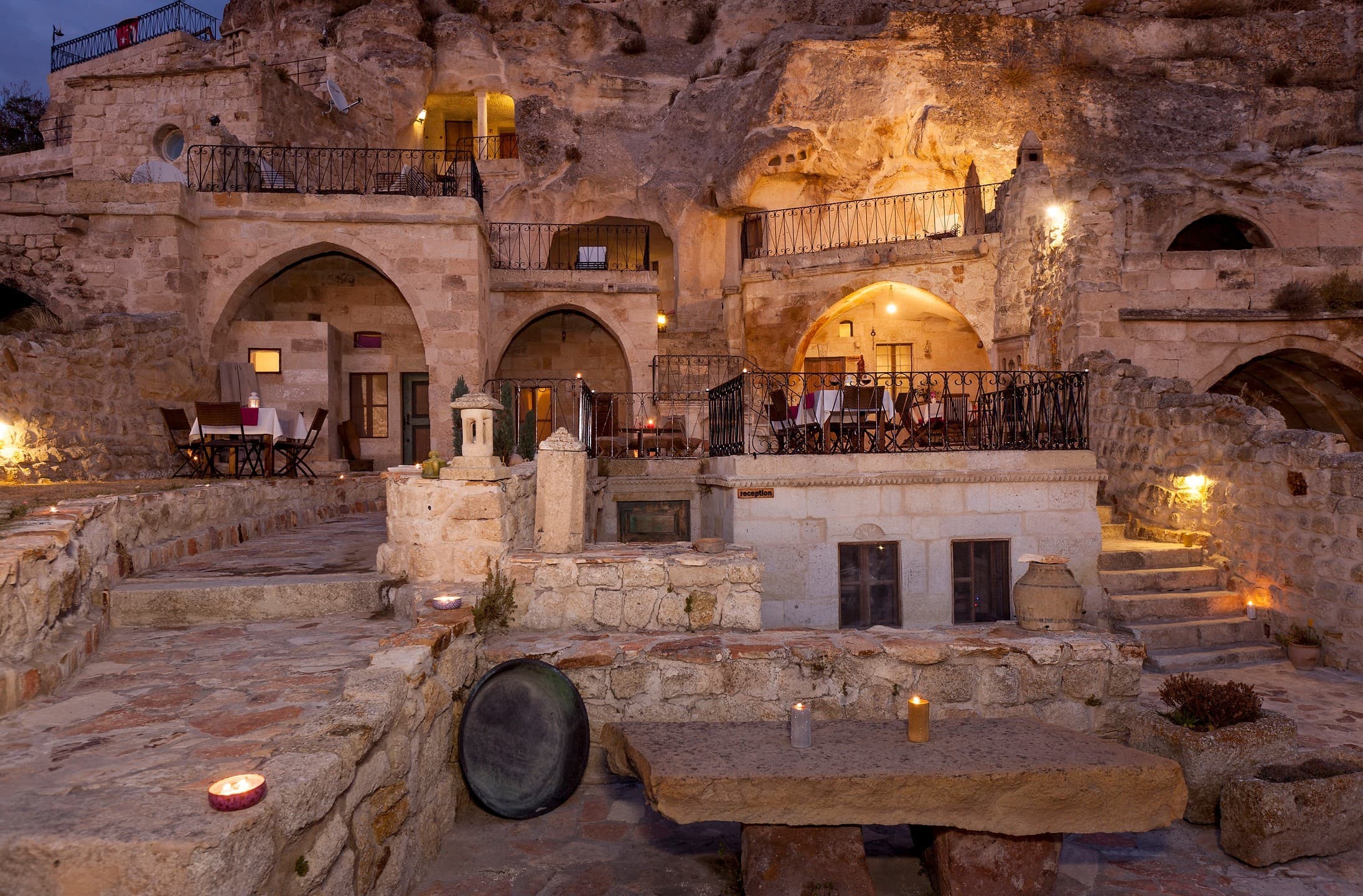 An Anatolian caravanserai with tall stone arches at golden hour.