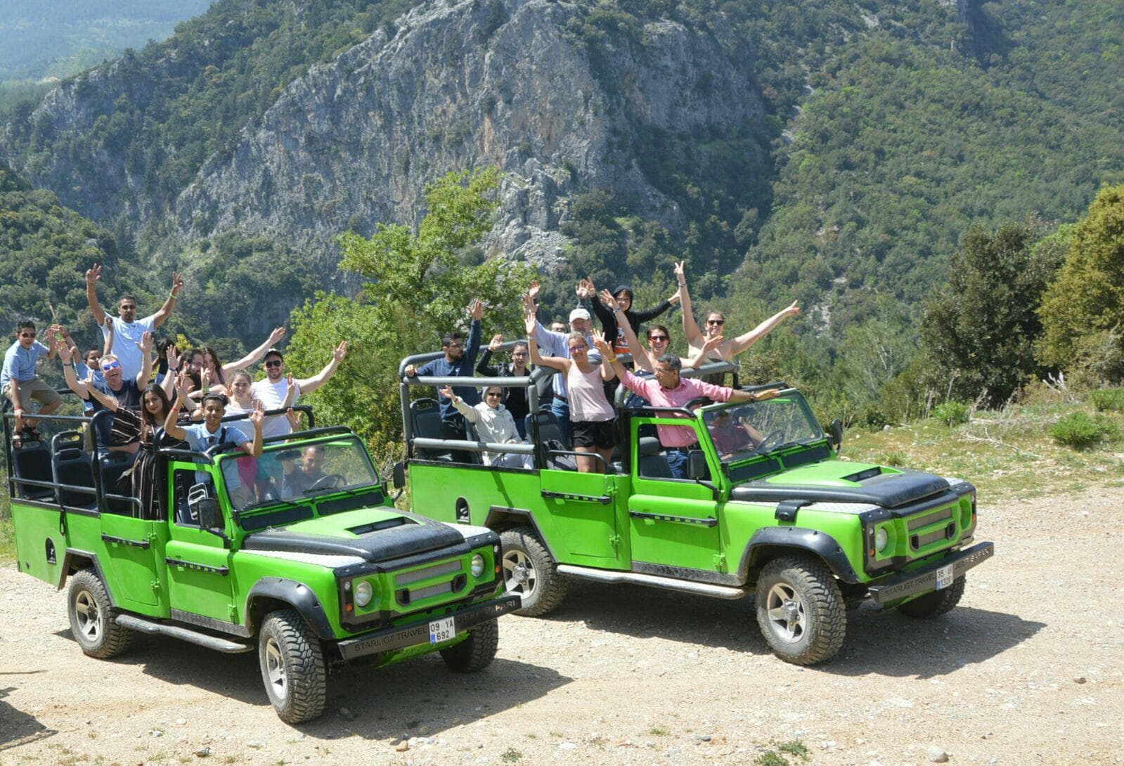 A convoy of off-road jeeps crossing a forest track inside Dilek Peninsula National Park.