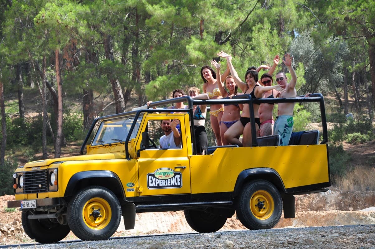 A convoy of off-road jeeps crossing a forest track inside Dilek Peninsula National Park.