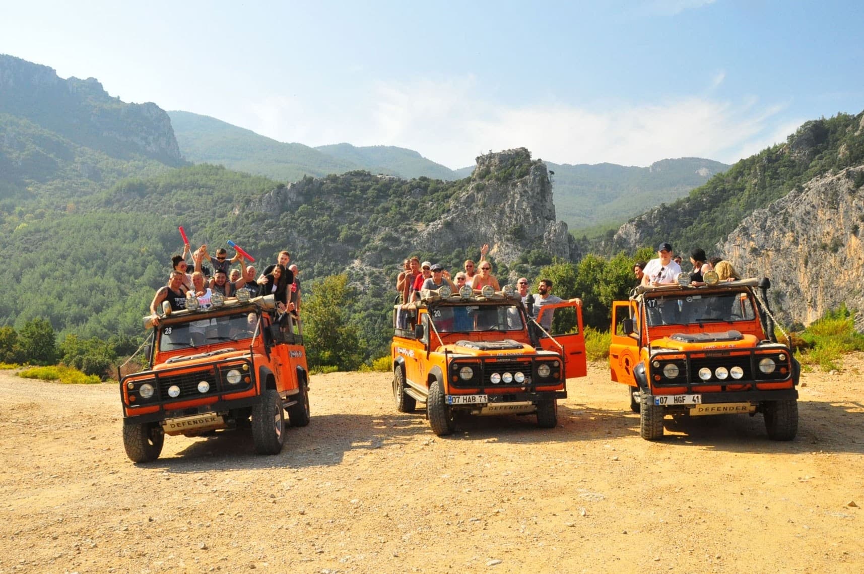 A convoy of off-road jeeps crossing a forest track inside Dilek Peninsula National Park.