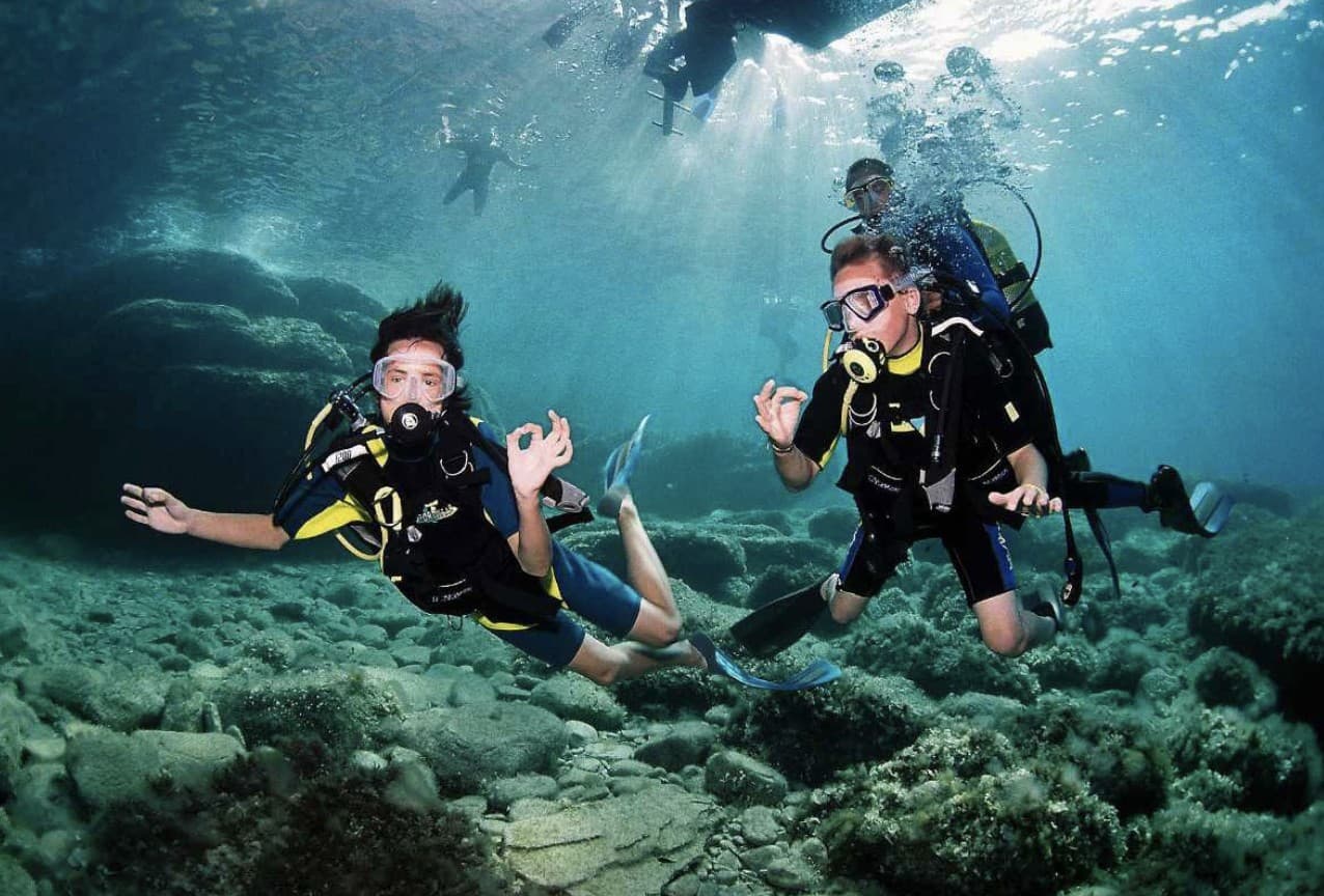A scuba diver exploring the clear turquoise waters of an Aegean reef near Kusadasi.