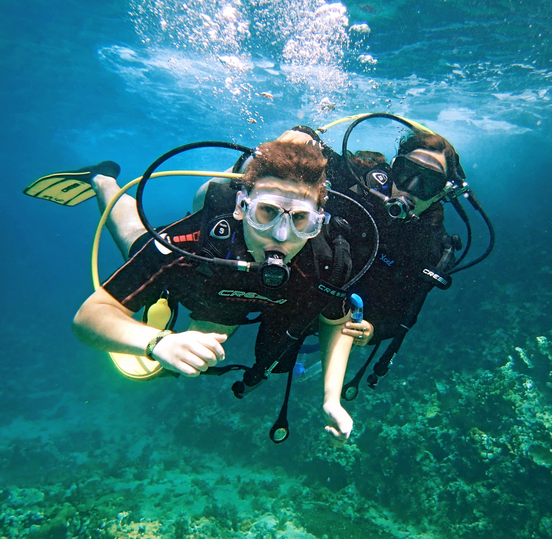 A scuba diver exploring the clear turquoise waters of an Aegean reef near Kusadasi.