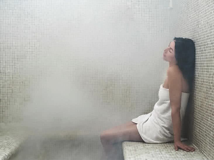 Steam rising over the heated marble göbektaşı of a traditional Turkish hamam.