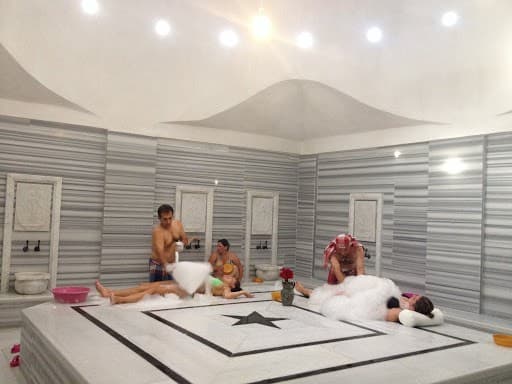 Steam rising over the heated marble göbektaşı of a traditional Turkish hamam.